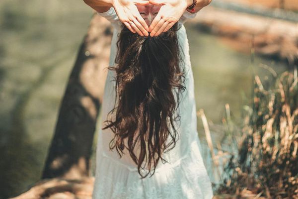 Person meditating in a serene natural environment.