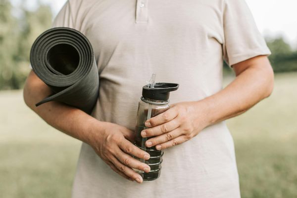 Yoga mat, blocks, and water bottle prepared for a session.